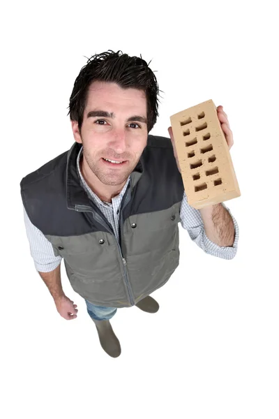 Craftsman holding a brick — Stock Photo, Image