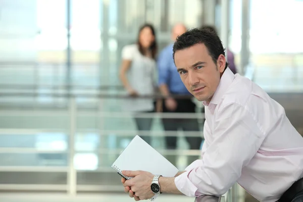 Businessman leaning on a balcony — Stock Photo, Image