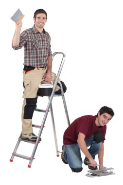 Two decorators working on site clipart