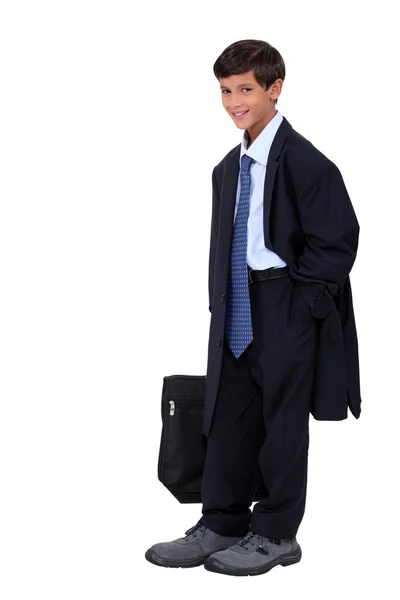 Young boy in an adult business suit — Stok fotoğraf