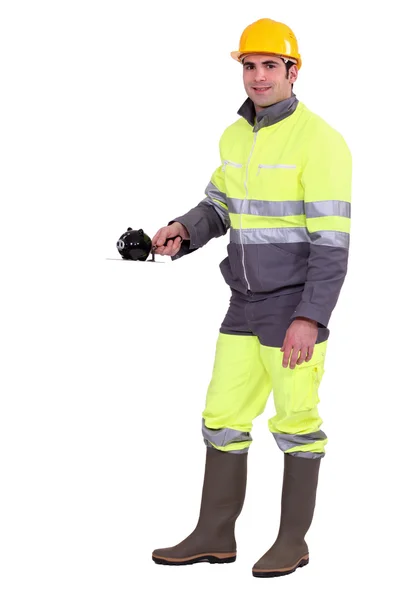 Construction worker with a piggy bank — Stock Photo, Image