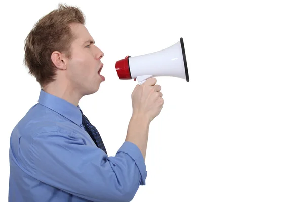 Young businessman shouting in loudspeaker — Stock Photo, Image