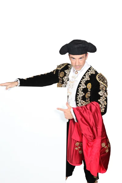 Mężczyzna ubrany jak matador stał pusty przekaz deska — Zdjęcie stockowe