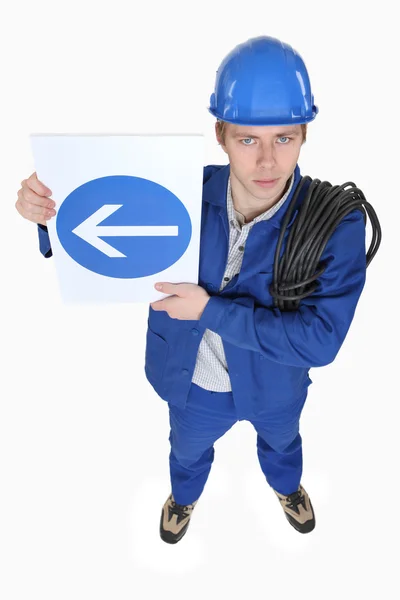 Werknemer met een unidirectionele teken — Stockfoto