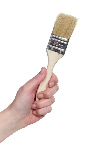 En bild av en hand som håller en målning borste. — Stockfoto