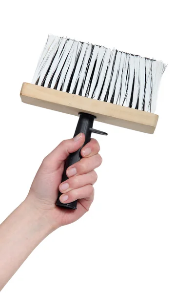 Main tenant une brosse de papier peint — Photo