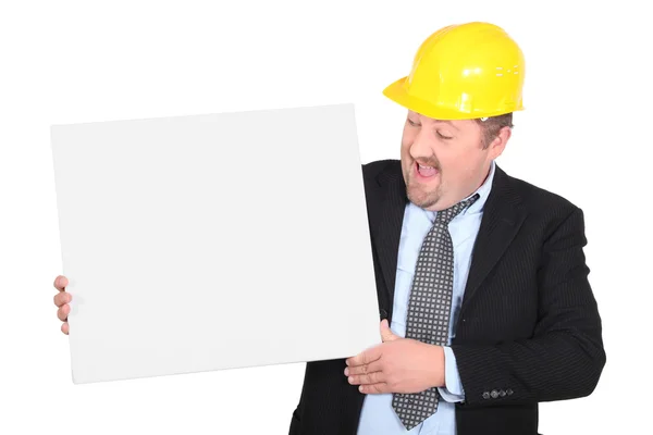 Man in pak dragen gele helm met canvas — Stockfoto
