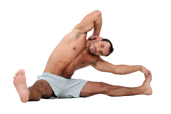 Man stretching on the floor — Stock Photo, Image