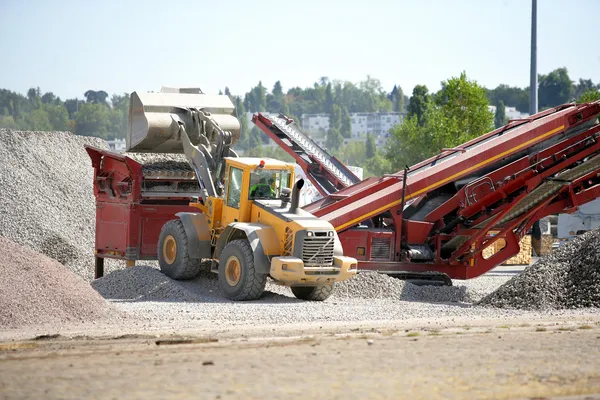 Digger transferring quarried materials — Stock Photo, Image