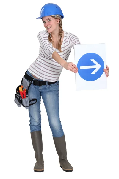 Woman with a one way sign — Stock Photo, Image