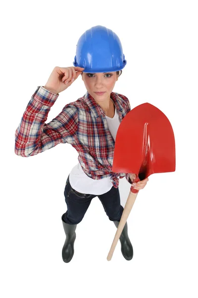 Assertive tradeswoman holding a spade — Stock Photo, Image