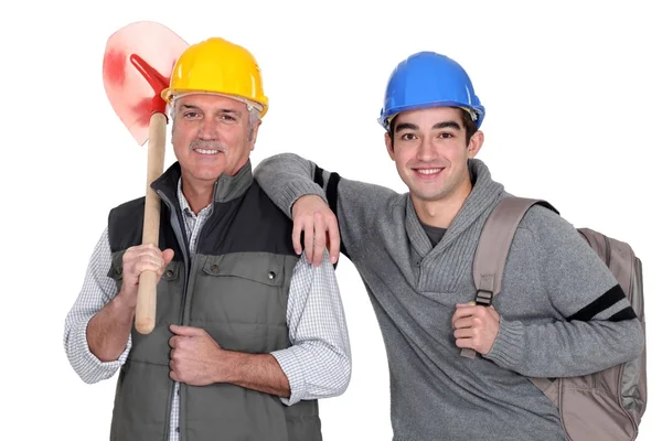 Experienced tradesman posing with his new apprentice — Stock Photo, Image