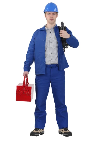 Electrician carrying cable and tool box — Stockfoto