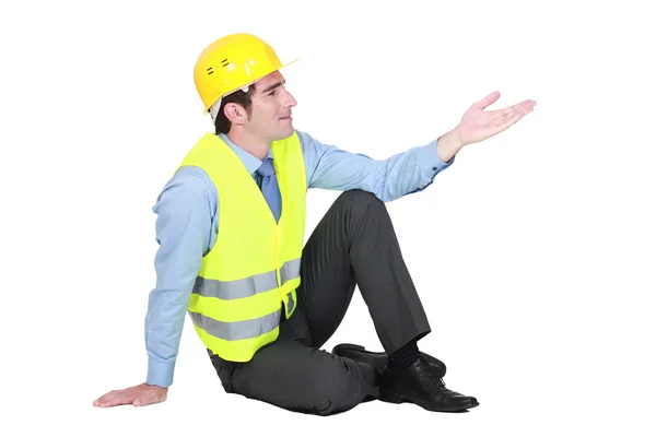 Man sitting down wearing fluorescent jacket — Stock Photo, Image