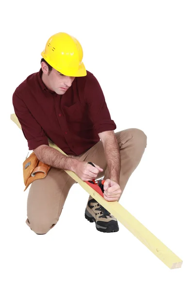 Carpenter using a plane — Stock Photo, Image