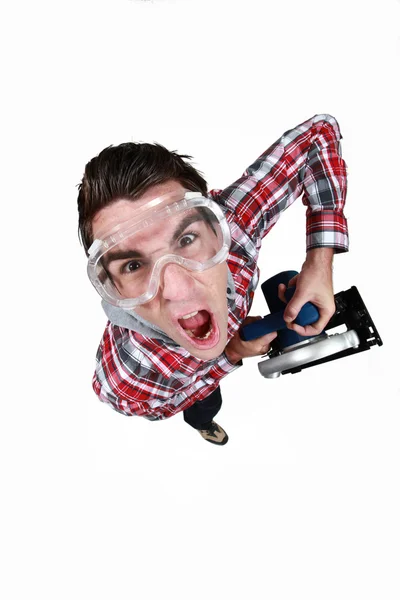 High angle shot of tradesman wearing goggles in fist of rage — Stock Photo, Image