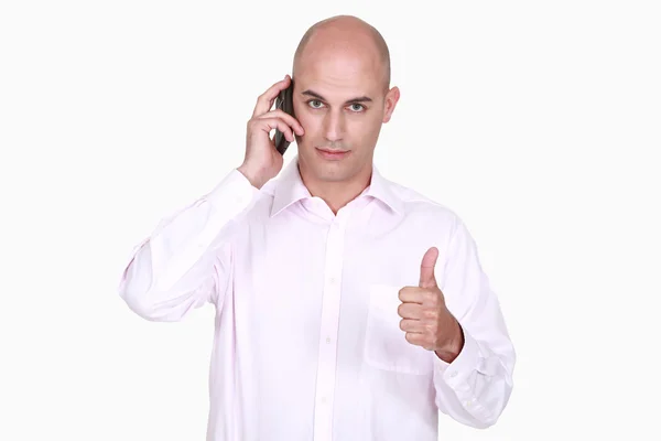 Ember beszél a telefonon, és amely a hüvelykujj — Stock Fotó