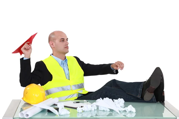 Bored foreman throwing paper airplane — Stock Photo, Image