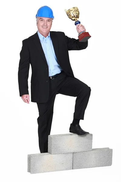 Businessman holding trophy — Stock Photo, Image