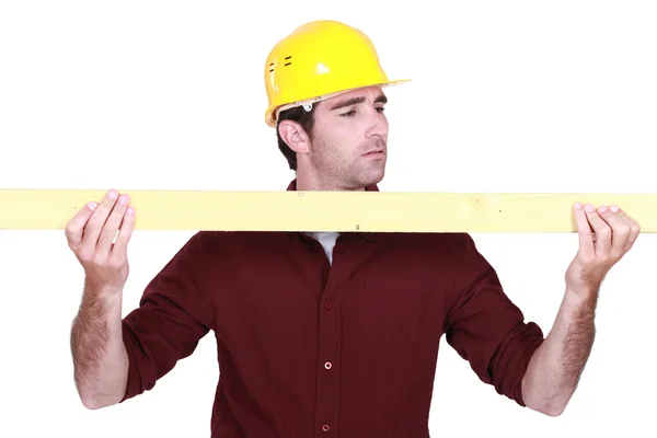 Workman holding a plank — Stock Photo, Image
