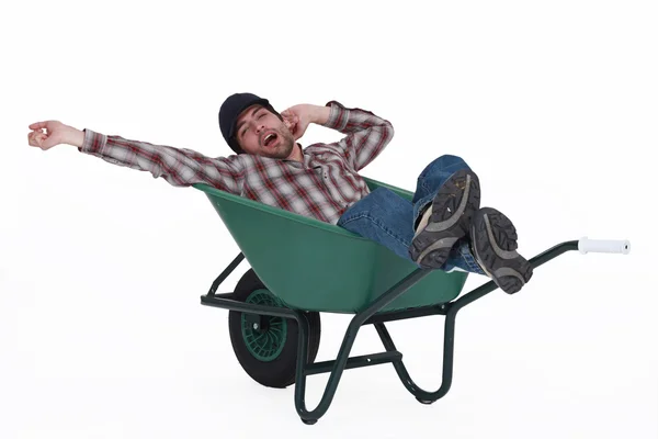 Man dozing in a wheelbarrow — Stock Photo, Image