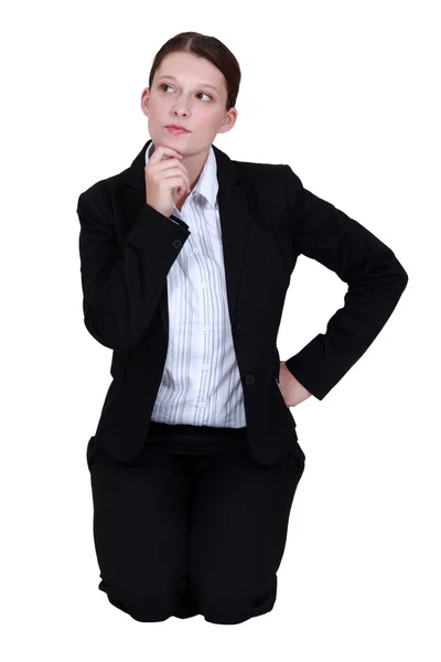 Businesswoman thinking and holding her chin — Stock Photo, Image