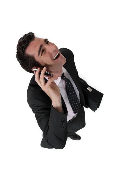 Businessman talking on his cell and laughing — Stock Photo, Image