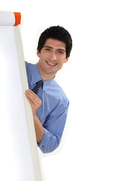 Businessman standing behind a white board — Stock Photo, Image