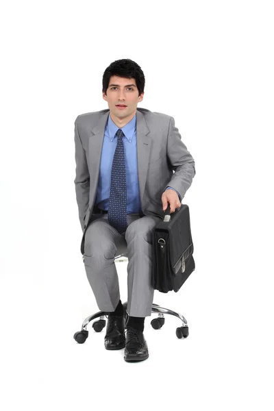 Businessman sat with briefcase — Stock Photo, Image
