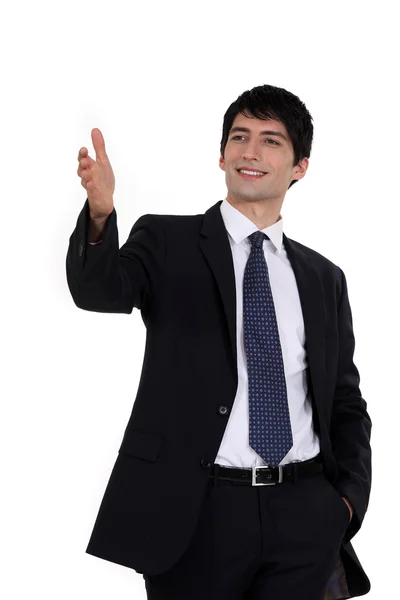 Happy businessman directing with hand — Stock Photo, Image