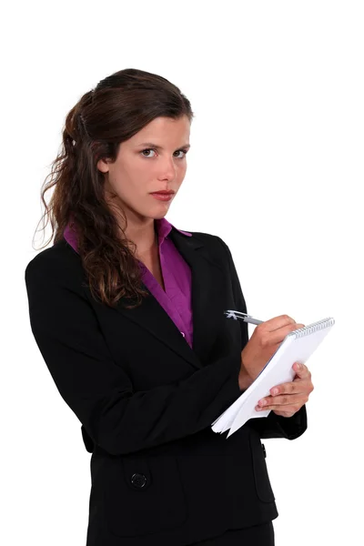 Woman writing on notepad — Stock Photo, Image