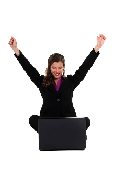 Triumphant woman with a laptop Stock Photo