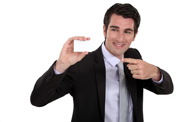 Homem apontando para o cartão comercial — Fotografia de Stock