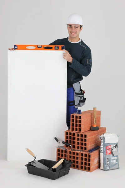 Young bricklayer posing with copyspace — Stock Photo, Image