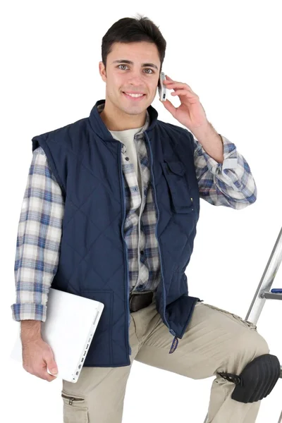 Tiler with mobile phone and equipment — Stock Photo, Image