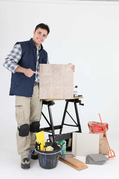 Tiler pointing at his product — Stock Photo, Image