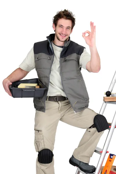 Approving tile fitter posing with his tools and building materials — Stock Photo, Image