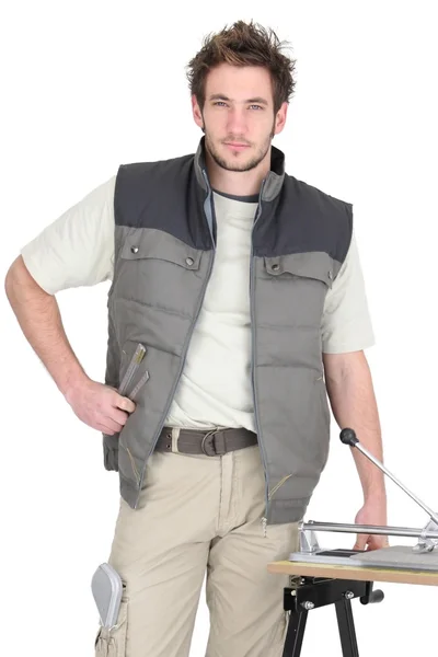 Professional tile fitter posing with his building materials and tools — Stock Photo, Image