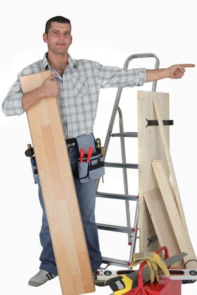 Carpenter pointing at empty copy space — Stock Photo, Image