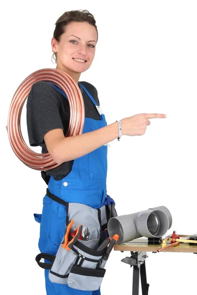 Female plumber pointing — Stock Photo, Image