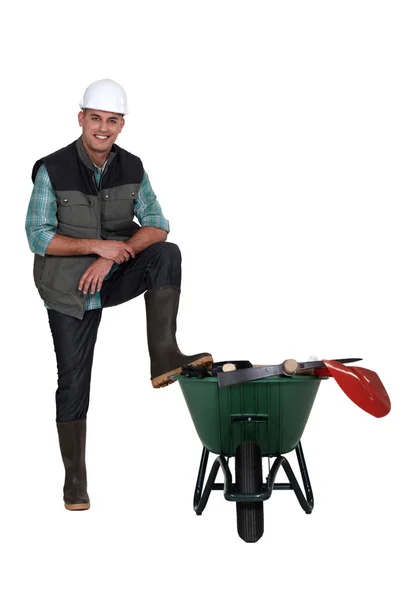 Worker with a wheelbarrow — Stock Photo, Image