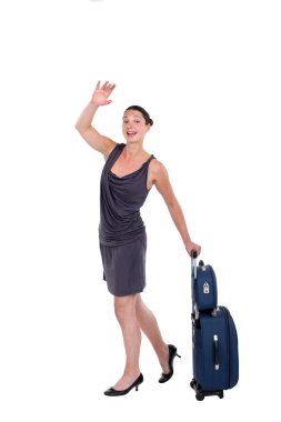 Woman with luggage hailing a taxi clipart