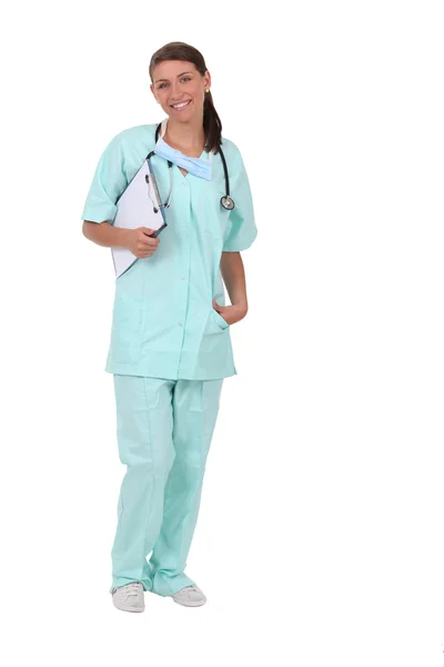 Woman in scrubs with stethoscope and clipboard — Stock Photo, Image