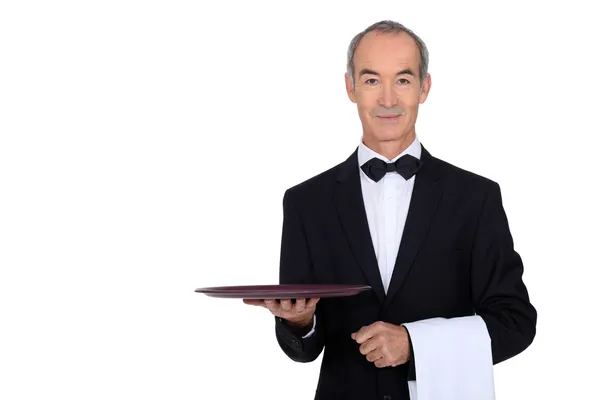 Waiter in tuxedo holding a plate — Stock Photo, Image