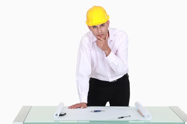 Pensive architect stood by his desk — Stock Photo, Image