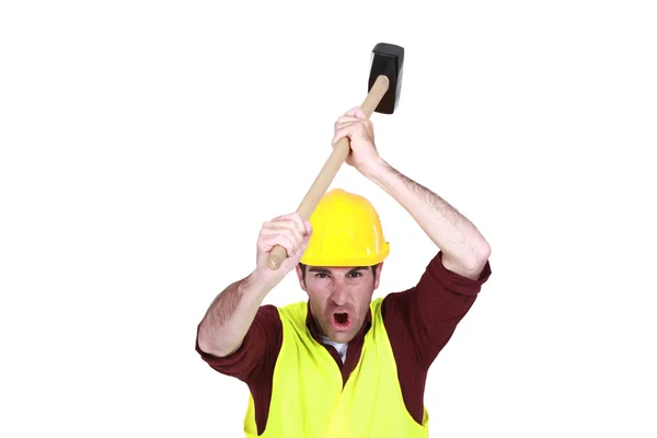 Construction worker about to bang an object with a mallet — Stock Photo, Image