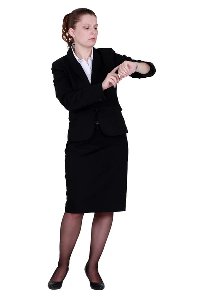 Businesswoman looking at wrist watch Royalty Free Stock Photos
