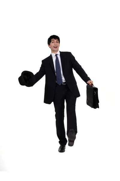 Man in a suit with briefcase and hat Stock Image