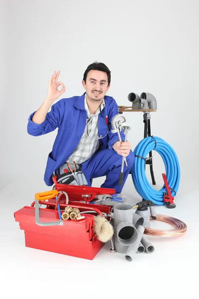 Plumber surrounded by equipment — Stock Photo, Image