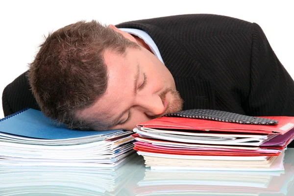 Zakenman in slaap op een stapel van papierwerk — Stockfoto